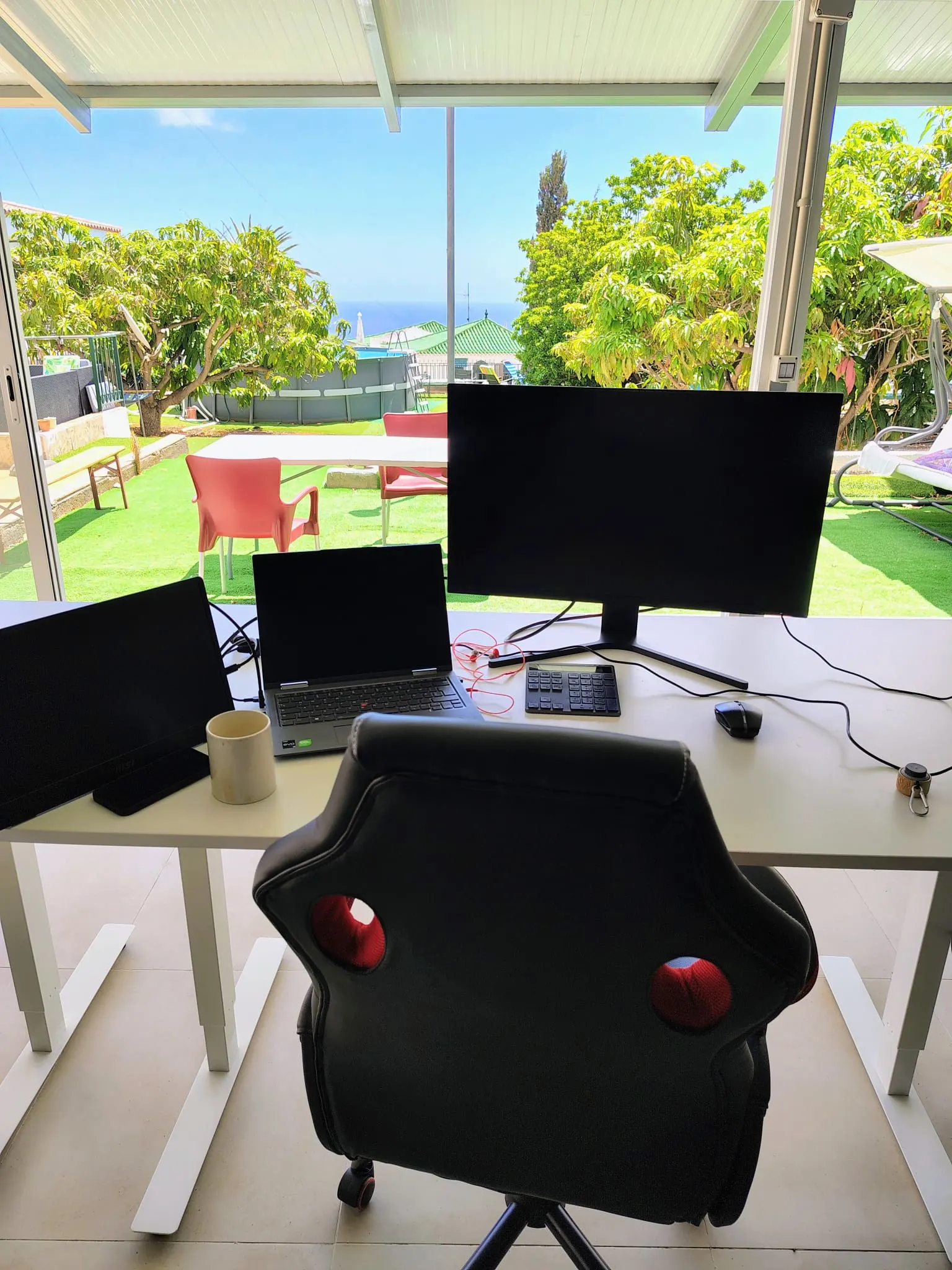 Vertical view of the Blue Paradise coworking room and sea-facing windows.